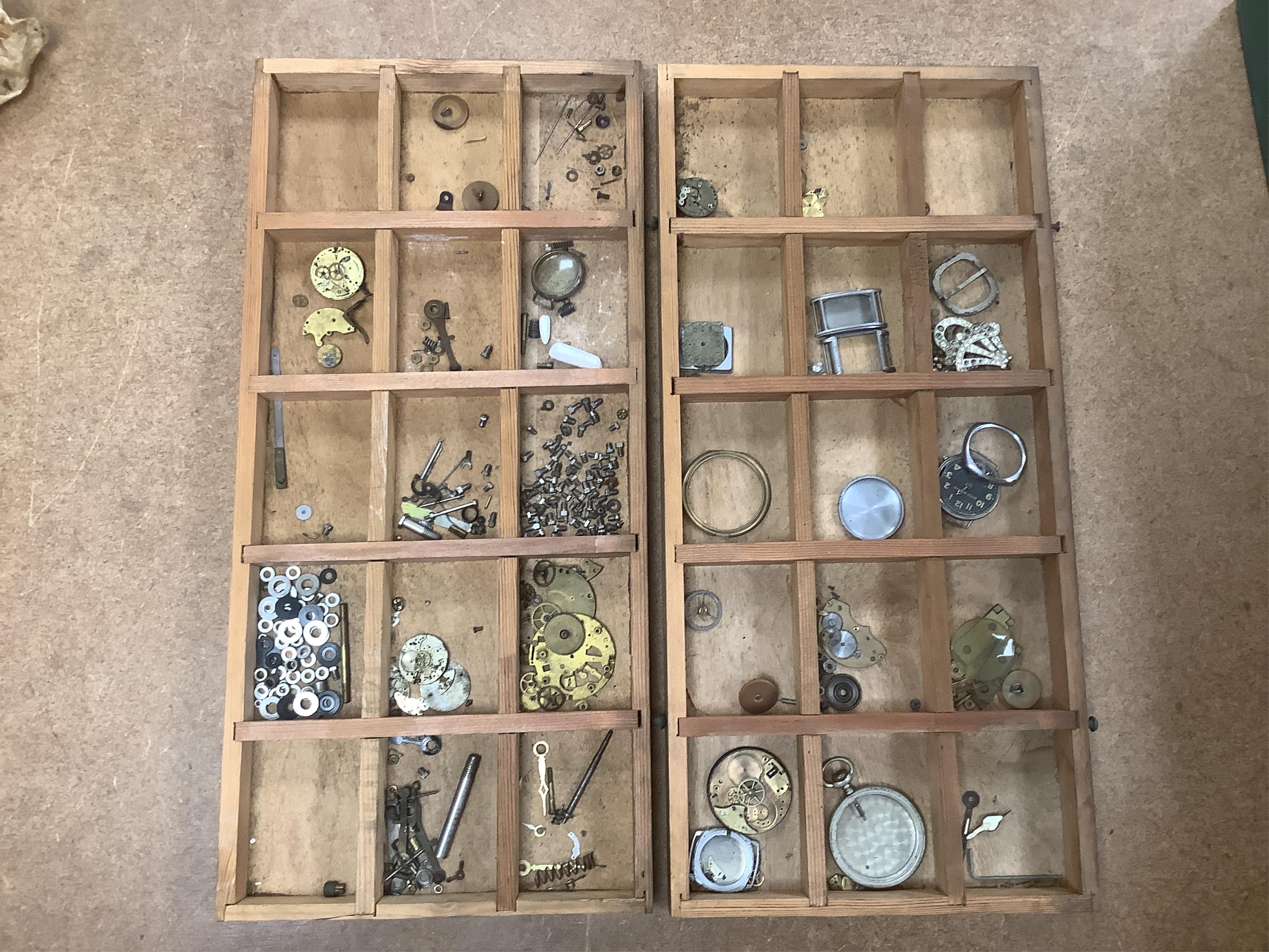 A wooden twelve drawer cabinet containing a collection of watch parts. Condition - cabinet fair to good, watch parts as found